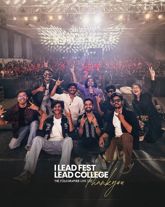 Fest crew posing on stage with the crowd cheering behind them