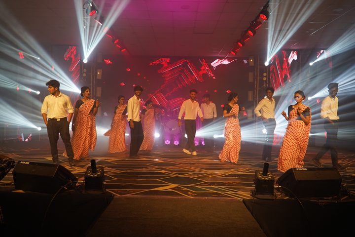 Dancers in polka-dot saris performing on the culturals stage